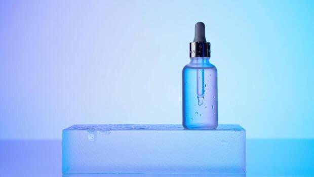 Blue serum dropper bottle on a frosted glass block with gradient background photo