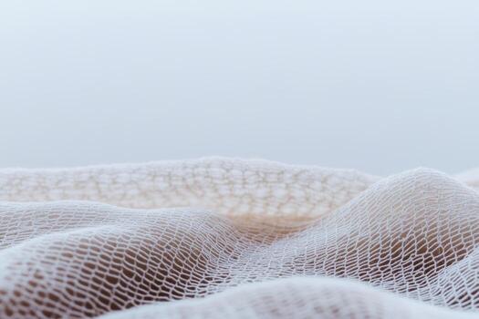 Soft white fabric draping in gentle waves with a calm background photo