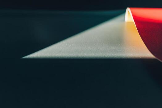 Colorful roll of paper casting a shadow on the surface photo