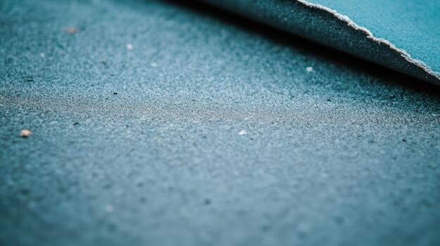 Sandpaper texture showcasing fine grit and edge detail in crafting setting photo