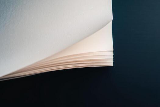 Close-up of stacked blank pages on a dark surface in natural light photo