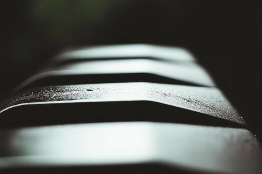 Textured metal surface with droplets captured in soft light photo