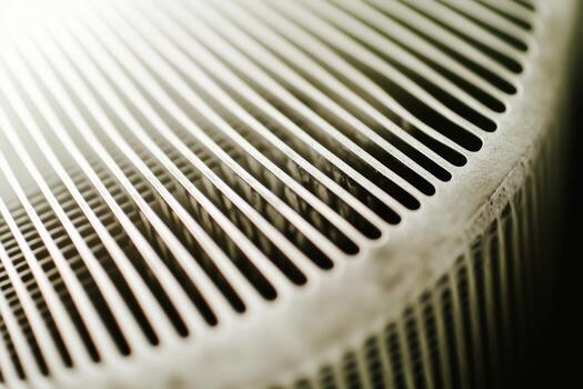 Detailed view of a textured air conditioning unit in a warm indoor setting photo