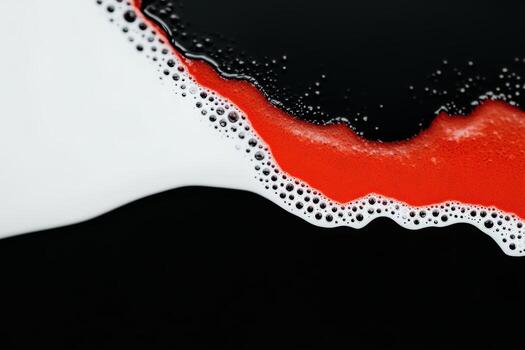 Colorful foam creates an abstract pattern against a dark background photo