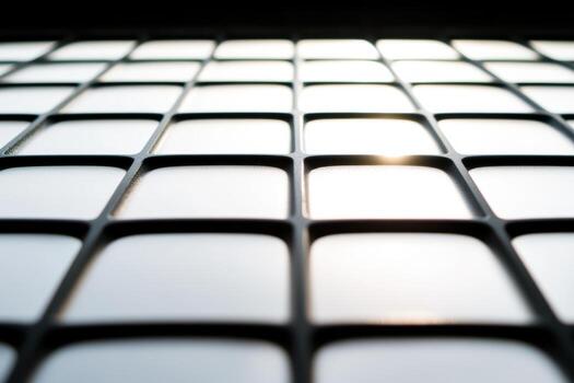 Grid pattern with reflections capturing light from a bright source photo