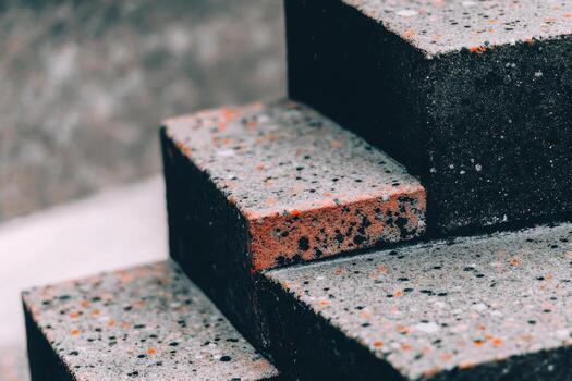 Close-up view of textured concrete steps with colorful specks in urban setting photo