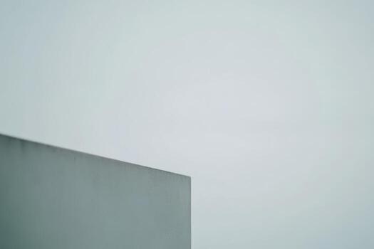 Minimalist architectural structure against a soft gray sky in early morning photo