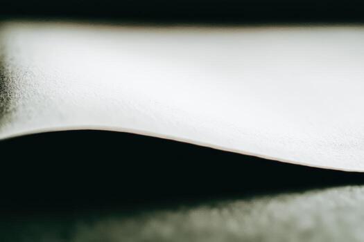 Close-up view of textured paper with gentle curves and shades photo