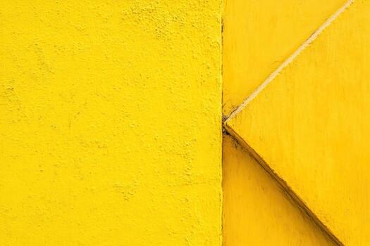 Bright yellow wall with geometric texture in urban setting photo