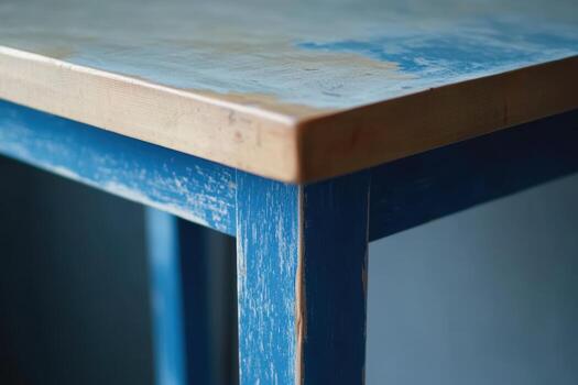 Close-up view of a weathered blue table showcasing rustic charm and details photo