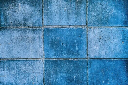 Textured blue tiles arranged in a grid pattern on a surface photo