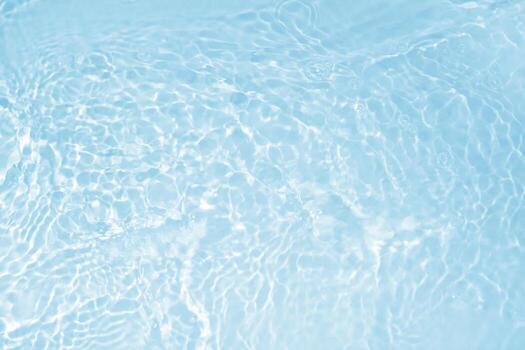 Water background with small bubbles. transparent water surface with splashes and wave texture with ripples. Top view, a place to copy. Background with clear blue water. photo