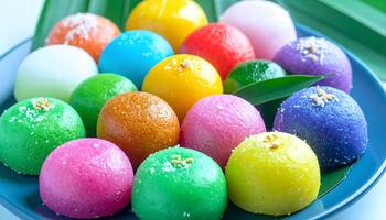 Colorful Sweet Mochi Balls on a Blue Plate. photo
