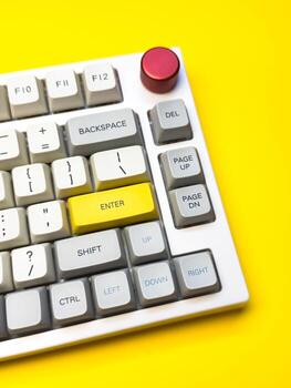 White mechanical keyboard minimalism, keyboard buttons. A keyboard with a yellow key on the bottom left photo