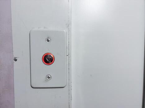 Elevator call button, new button in old house, silver button with red backlight photo