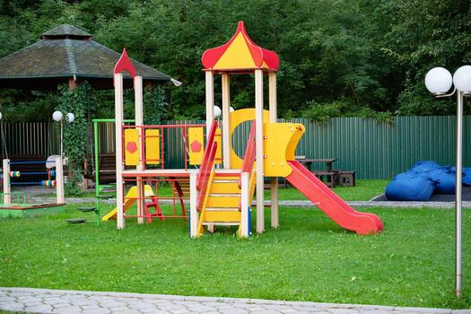 Colorful playground with slide and climbing structure in park. Activiity in nature. photo