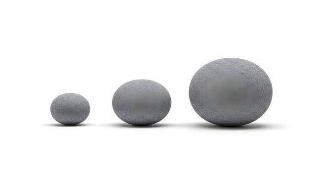 Three textured grey spheres of increasing size arranged in a line on a simple white background, representing growth or progression photo