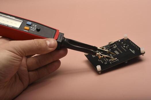 The SMD component tester. Investigation of the parameters of the SMD components using a tester probe. photo