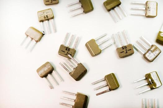 Different transistors on a white table. Electronics components. photo