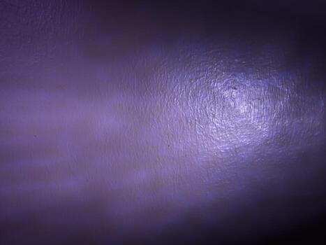 House wall glowing with purple light reflections in the dark photo