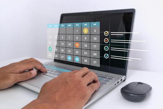 A man working on laptop to organize schedule and optimizing workflow efficiently. Time management concept. photo