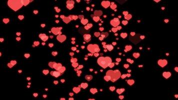 Many red hearts are flying in the air on a black background video