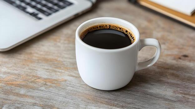 Desk Setup with Laptop,Coffee Cup,and Notepad on Wooden Background for Productivity Themes photo