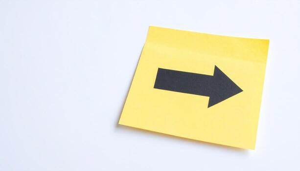 Close up sticky note arrow pointing detail with blank copy space around office stationery reminder paper organization design advertising background photo