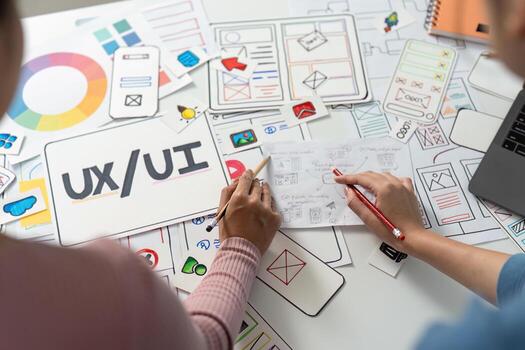 UX and UI Design Focus. Designers sketching user interface wireframes on a table. photo
