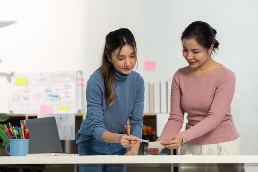 UX and UI Design Collaboration. Two women discussing user interface ideas in a creative workspace. photo