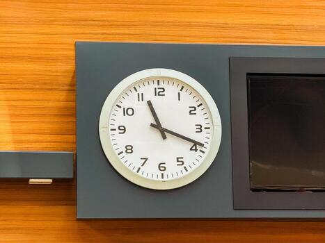 Wall clock showing time in public terminal interior. Time, schedule, and coordination in structured travel and daily environments. photo