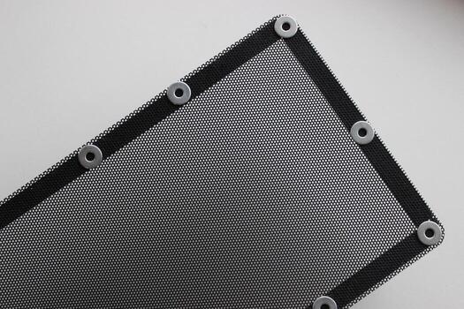 Pattern of protective grill with small round holes and mounting bracket on the frame isolated on white photo