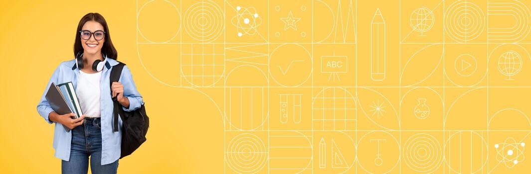 A student stands confidently with a backpack and books, smiling at the camera. The bright yellow background features educational graphics, creating an inviting atmosphere for learning. photo