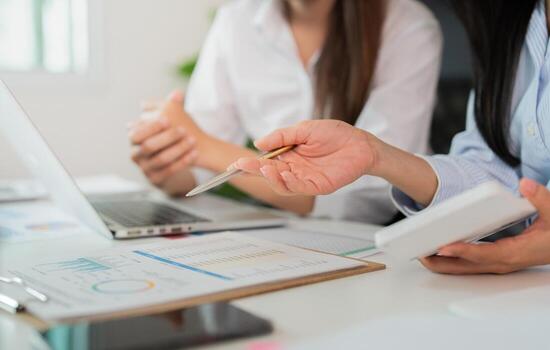 Teamwork in Action. Close-up of hands discussing data analysis in a business meeting. photo