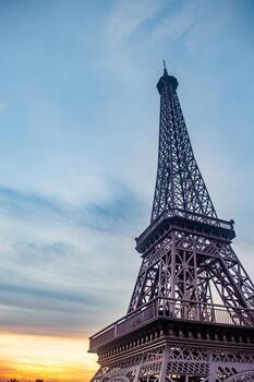 The eiffel tower rises against a vibrant sky, showcasing its intricate ironwork and iconic silhouette. This image captures the essence of parisian architecture and travel destinations. photo