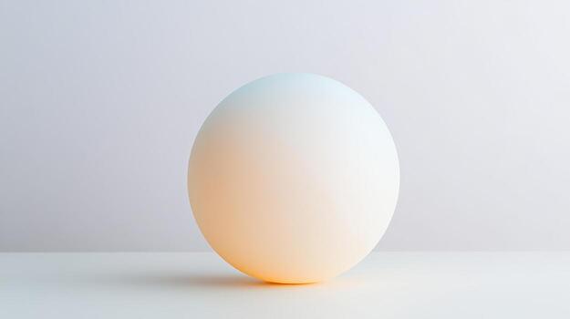 A smooth sphere showcases a gentle gradient of color while positioned on a minimalistic surface illuminated with soft light photo