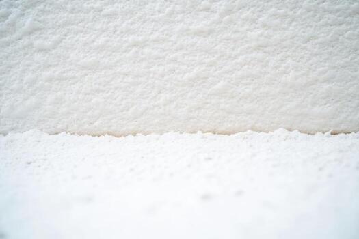 Textured white surface with fine details and soft shadows in natural light photo