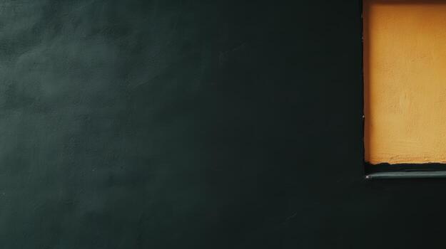 Bright orange window contrasts with dark wall in urban setting photo