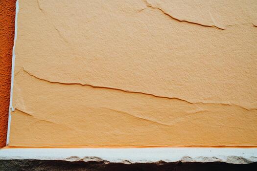 Textured wall surface in warm orange tone with subtle patterns and lines photo