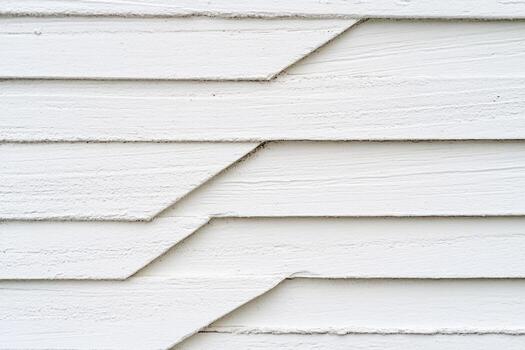 Textured white wall with overlapping panels in close view photo