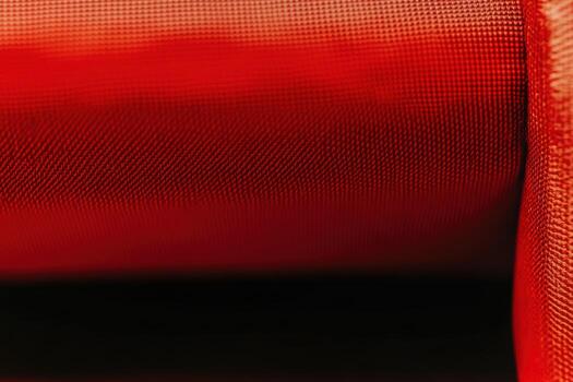 Close-up of vibrant red fabric showcasing texture and detail in natural light photo