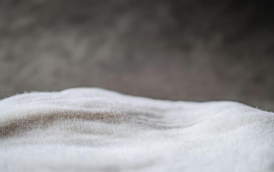 Soft textured fabric displayed on a neutral background in natural light photo