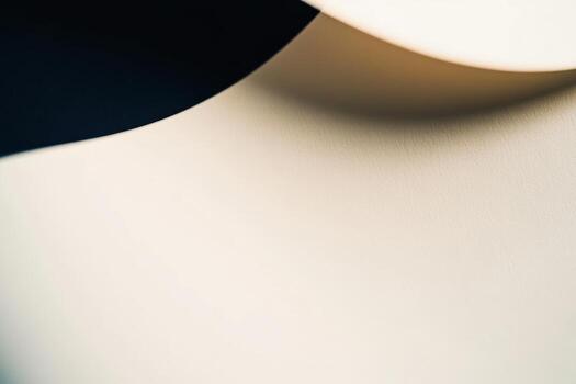 Smooth cream colored surface with gentle curves and shadows in close detail photo