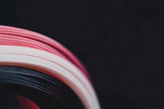 Colorful textured cords arranged in a circular pattern on a dark background photo
