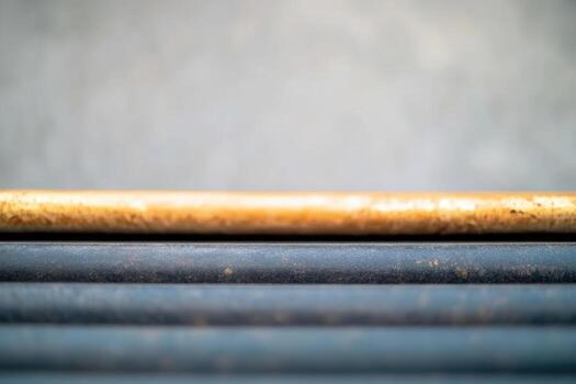 Multiple parallel rods displayed in an industrial setting during daylight photo