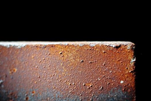 Rusty metal surface showing texture and color variations in close-up shot photo