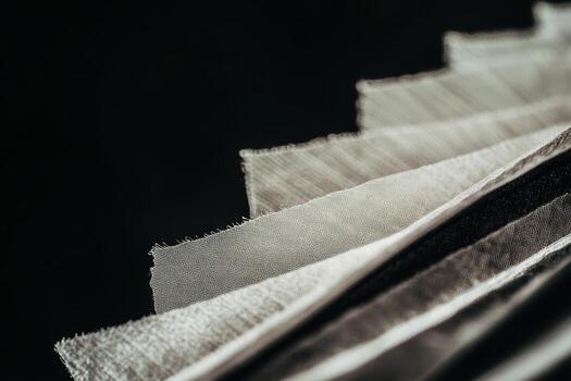 Different fabrics arranged in layers showcasing texture and color variations photo