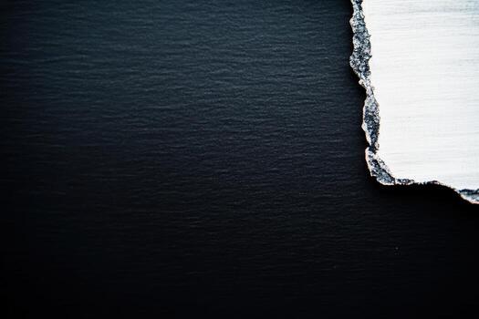 Abstract texture of black and white material contrasting on dark surface photo