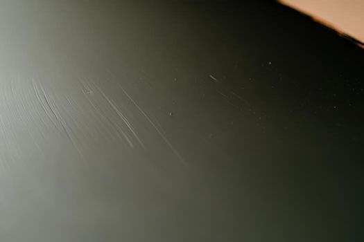 Close-up of a textured black surface with minor scratches photo