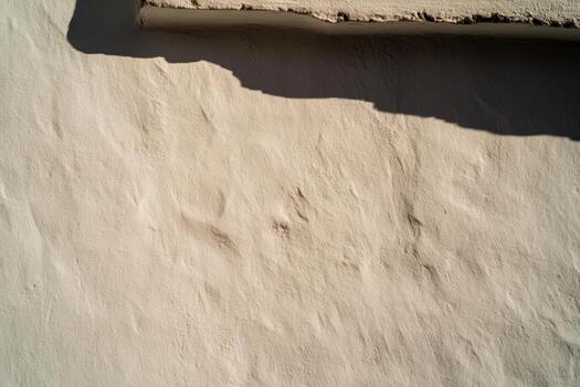 Textured wall with shadow creates an interesting visual effect in sunlight photo